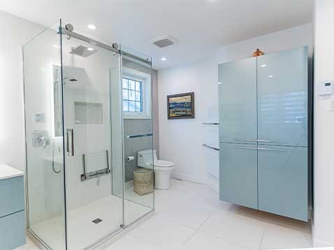 Bright blue and white bathroom with a glass shower